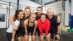 Group Of Happy Athletes Standing At cross fitness box